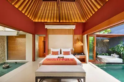a bedroom with a bed and a swimming pool at Bahira Lovely 1 BR Grand Pool Villa With Bathtub in Legian