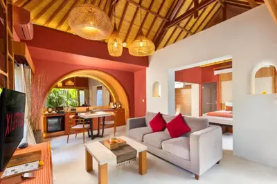 a living room with a couch and a table at Bahira Lovely 1 BR Grand Pool Villa With Bathtub in Legian