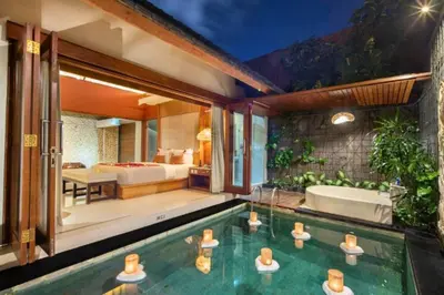 a house with a swimming pool and a bed and a tub at Bahira Lovely 1 BR Grand Pool Villa With Bathtub in Legian