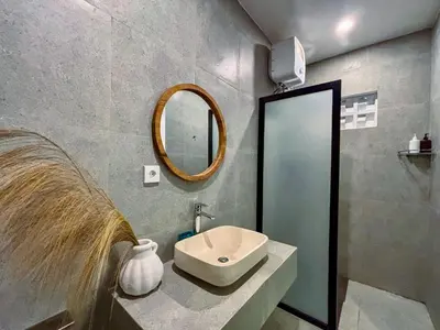 a bathroom with a sink and a mirror at Soane Summer House by AGATA in Seminyak