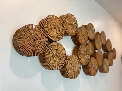 a bunch of brown plates on a wall at Soane Summer House by AGATA in Seminyak
