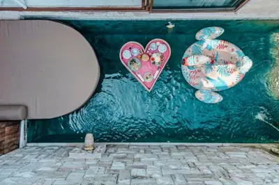 a wall with a painting of a toilet and a heart at Evelyn Grand 1 BR Private Pool Villa With Bathtub in Legian