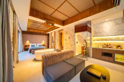 a living room with a couch and a bed at Evelyn Grand 1 BR Private Pool Villa With Bathtub in Legian