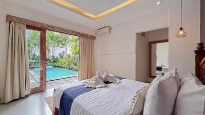 a bedroom with a bed and a swimming pool at New 2BR Mahaprada Private Pool in Seminyak in Seminyak