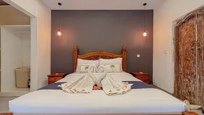 a bedroom with a bed with white sheets and two towels at New 2BR Mahaprada Private Pool in Seminyak in Seminyak