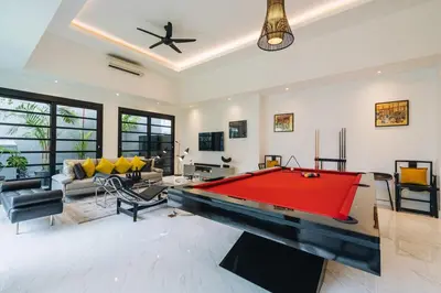 a living room with a pool table in it at Modern 2BR Pool Villa in Umalas with Billiard & Long Pool in Canggu