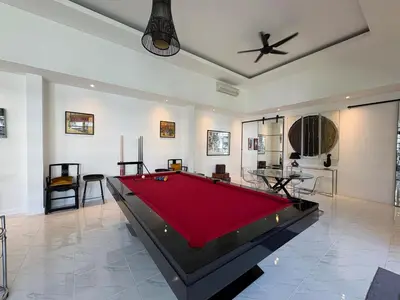 a living room with a pool table in it at Modern 2BR Pool Villa in Umalas with Billiard & Long Pool in Canggu