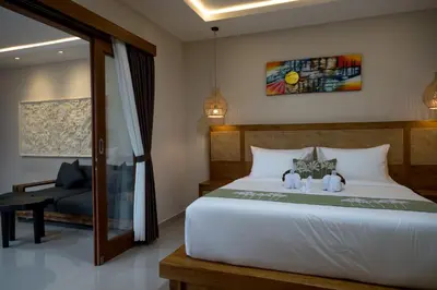 a bedroom with a bed with two stuffed animals on it at Villa Inges 1 Seminyak in Seminyak