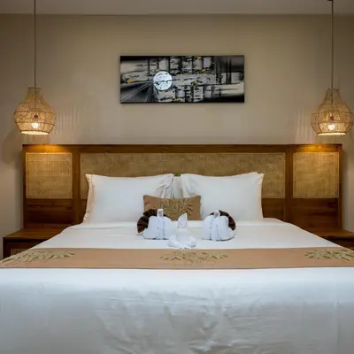two stuffed animals sitting on top of a bed at Villa Inges 2 Seminyak in Seminyak