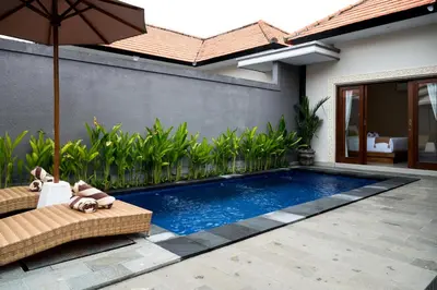 a swimming pool in the backyard of a house at Villa Inges 2 Seminyak in Seminyak