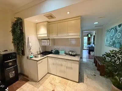a kitchen with white cabinets and a counter top at Apartment at Jayakarta Residence 6214 in Seminyak