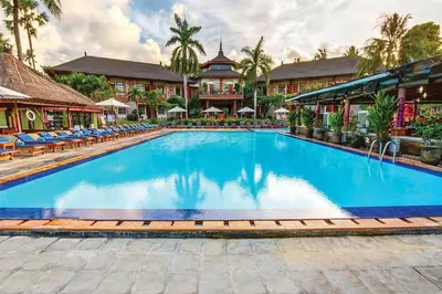 a pool at a resort with chairs and a building at Apartment at Jayakarta Residence 6214 in Seminyak