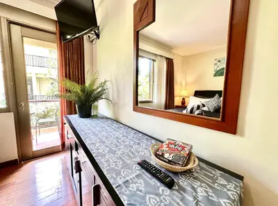 a table in a room with a mirror on the wall at Apartment at Jayakarta Residence 6214 in Seminyak
