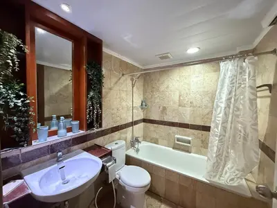 a bathroom with a sink and a tub and a toilet at Apartment at Jayakarta Residence 6214 in Seminyak