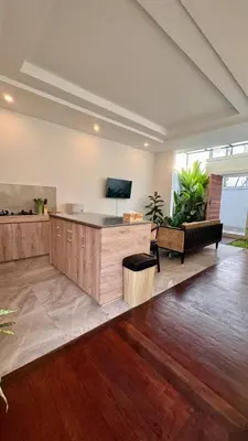 a large living room with a couch and a tv at Villa Harmaka 2 in Kerobokan