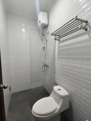 a bathroom with a white toilet and a shower at salah in Nusa Dua