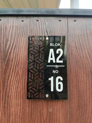 a sign on a wooden door with a black sign at salah in Nusa Dua