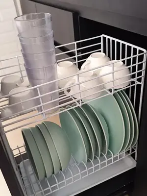 a rack of dishes and cups and plates in a refrigerator at salah in Nusa Dua
