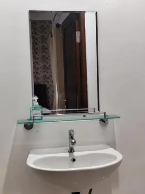 a sink with a mirror and a glass shelf above it at salah in Nusa Dua
