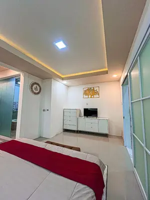 a bedroom with a bed and a tv in it at Private 5BR Jimbaran House with Pool, up to 12 Pax in Jimbaran