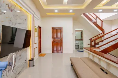 a living room with a staircase and a tv at Private 5BR Jimbaran House with Pool, up to 12 Pax in Jimbaran