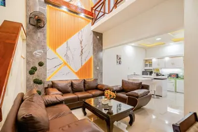 a living room with a couch and a table at Private 5BR Jimbaran House with Pool, up to 12 Pax in Jimbaran