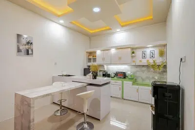 a kitchen with white cabinets and a white counter top at Private 5BR Jimbaran House with Pool, up to 12 Pax in Jimbaran