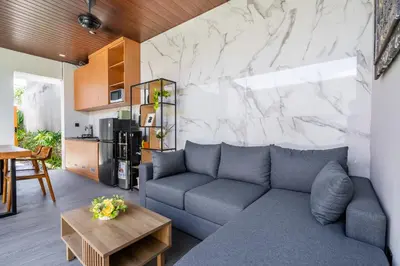 a living room with a couch and a table at Casa Benita 2 Villa Seminyak in Seminyak