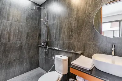 a bathroom with a toilet and a sink and a mirror at Casa Benita 2 Villa Seminyak in Seminyak