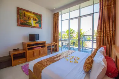 a bedroom with a bed and a large window at Villa Efes Bali in Seminyak