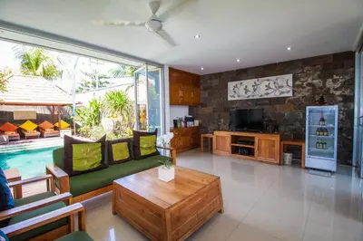 a living room with a couch and a table at Villa Efes Bali in Seminyak