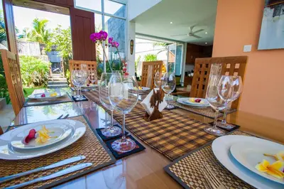 a dining room table with wine glasses on it at Villa Efes Bali in Seminyak