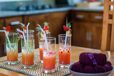 a group of four glasses with strawberries in them on a table at Villa Efes Bali in Seminyak