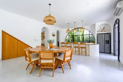 a kitchen and dining room with a wooden table and chairs at Ashlyn Elegant 4 BR Private Pool Villa in Canggu