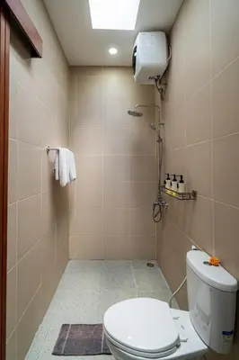 a bathroom with a toilet and a shower at Villa Paoua by BaliSuperHost in Seminyak