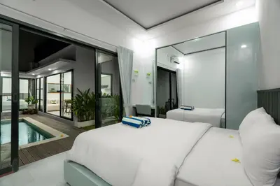 a bedroom with a bed and a swimming pool at Villa Paoua by BaliSuperHost in Seminyak