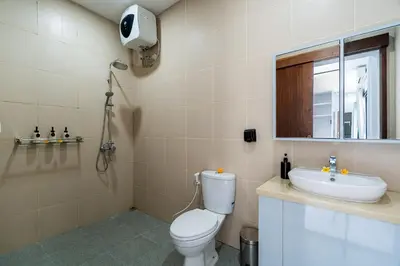 a bathroom with a toilet and a sink at Villa Paoua by BaliSuperHost in Seminyak