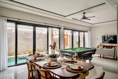 a living room with a table and a pool table at Villa Amani Seminyak in Seminyak