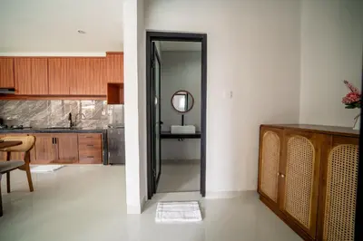 a kitchen with a sink and a mirror at Villa Amani Seminyak in Seminyak