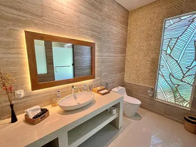 a bathroom with a sink and a mirror and a toilet at Villa Nishiki 5-Bedroom Private Villa in Seminyak in Seminyak