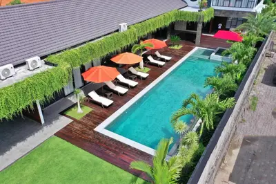 an overhead view of a swimming pool with chairs and umbrellas at Villa Nishiki 5-Bedroom Private Villa in Seminyak in Seminyak