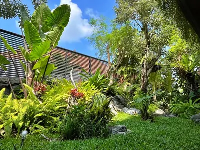 a garden with lush green plants and trees at Villa Nishiki 5-Bedroom Private Villa in Seminyak in Seminyak