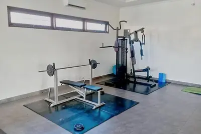 a gym with cardio equipment in a room at 3 Bd Pvt House with big common pool and Gym & BBQ in Nusa Dua