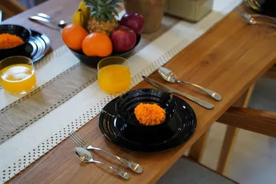 a plate of food on a table with fruit and juice at 3 Bd Pvt House with big common pool and Gym & BBQ in Nusa Dua