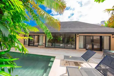 a house with a swimming pool next to a house at Amazing Private Pool Villa 2BR in Seminyak Bali in Kerobokan