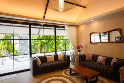 a living room with a couch and a large window at Amazing Private Pool Villa 2BR in Seminyak Bali in Kerobokan