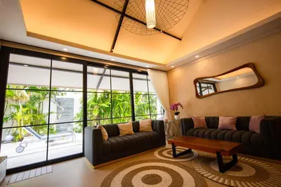 a living room with a couch and a table at Amazing Private Pool Villa 2BR in Seminyak Bali in Kerobokan