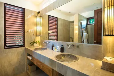 a bathroom with two sinks and a large mirror at Villa Abagram Anam in Seminyak
