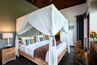 a bedroom with a bed with a canopy at Villa Abagram Anam in Seminyak