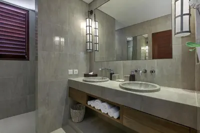 a bathroom with two sinks and a mirror at Villa Abagram Anam in Seminyak